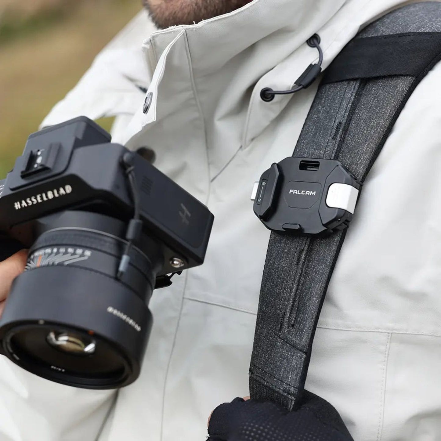F38 quick release camera backpack strap clip on gray strap, securing a camera rig