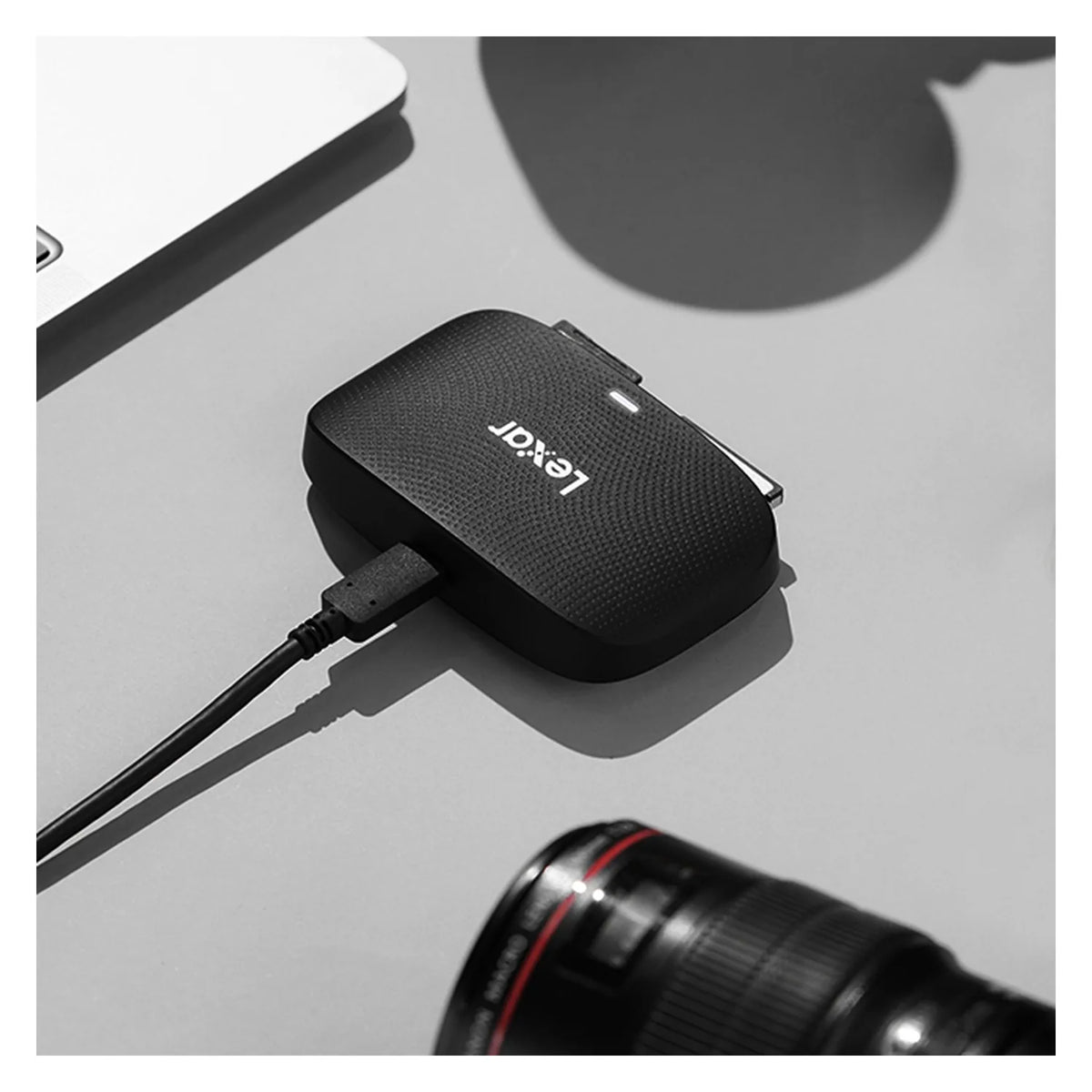 Black CFexpress Type B and SD card reader with connected cable; side ports visible