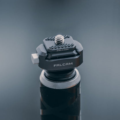 Camera quick release base with white screw knob and rotating plate, dark gray