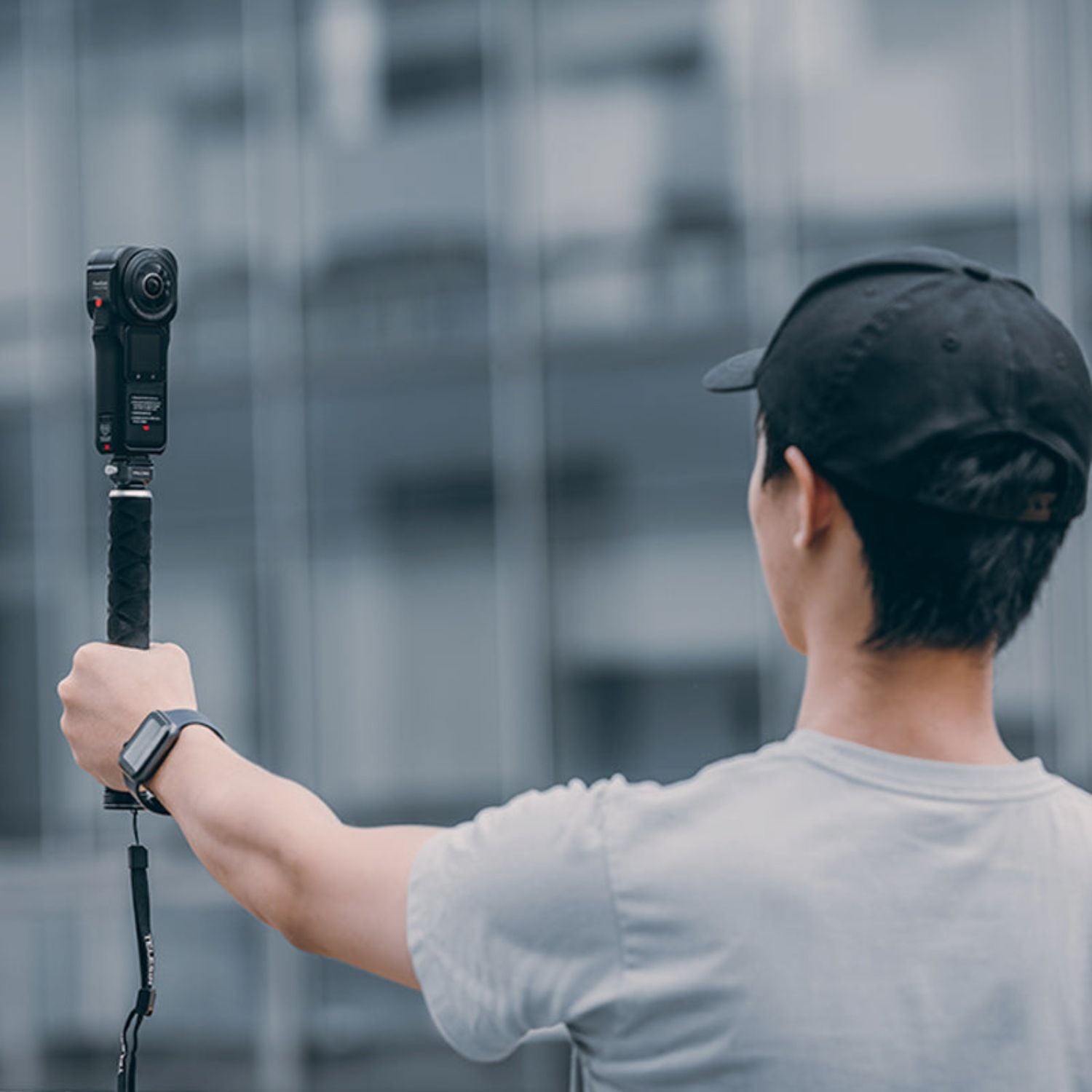 Camera quick release mount on a handheld pole with camera attached, dark gray