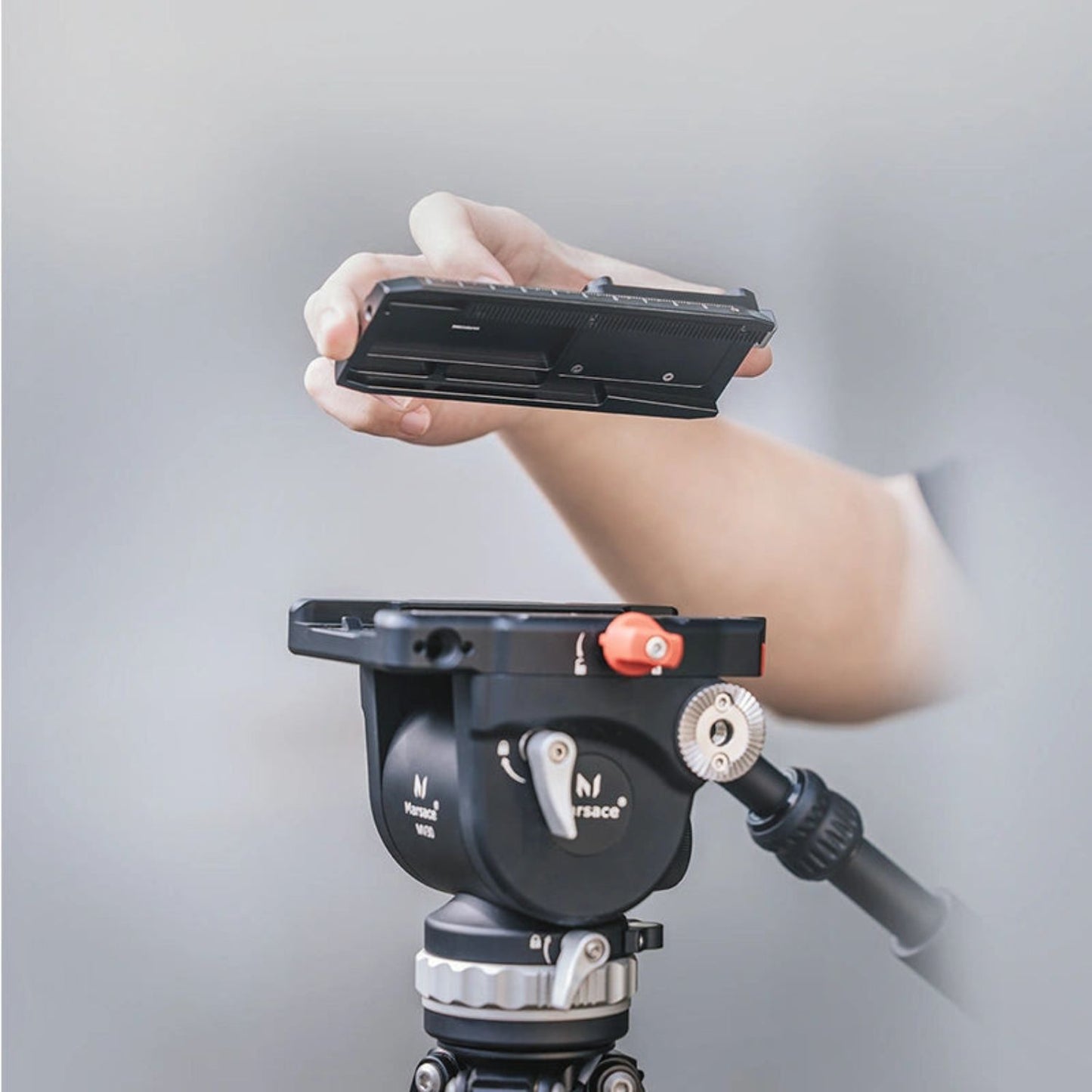 Falcam F38 quick release kit V2 quick-release plate held in hand with mounting head attached