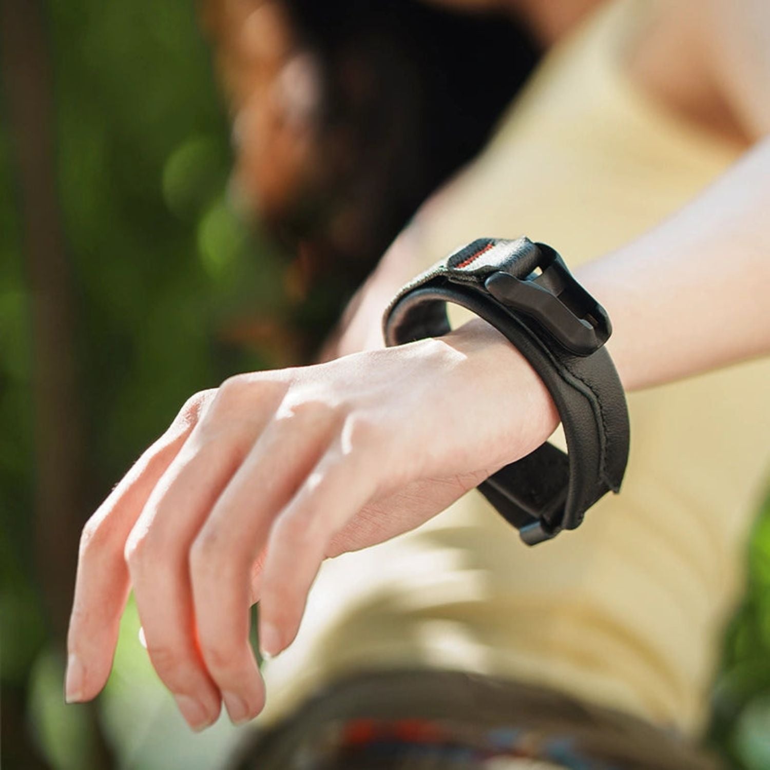 Black magnetic buckle wrist strap on a wrist