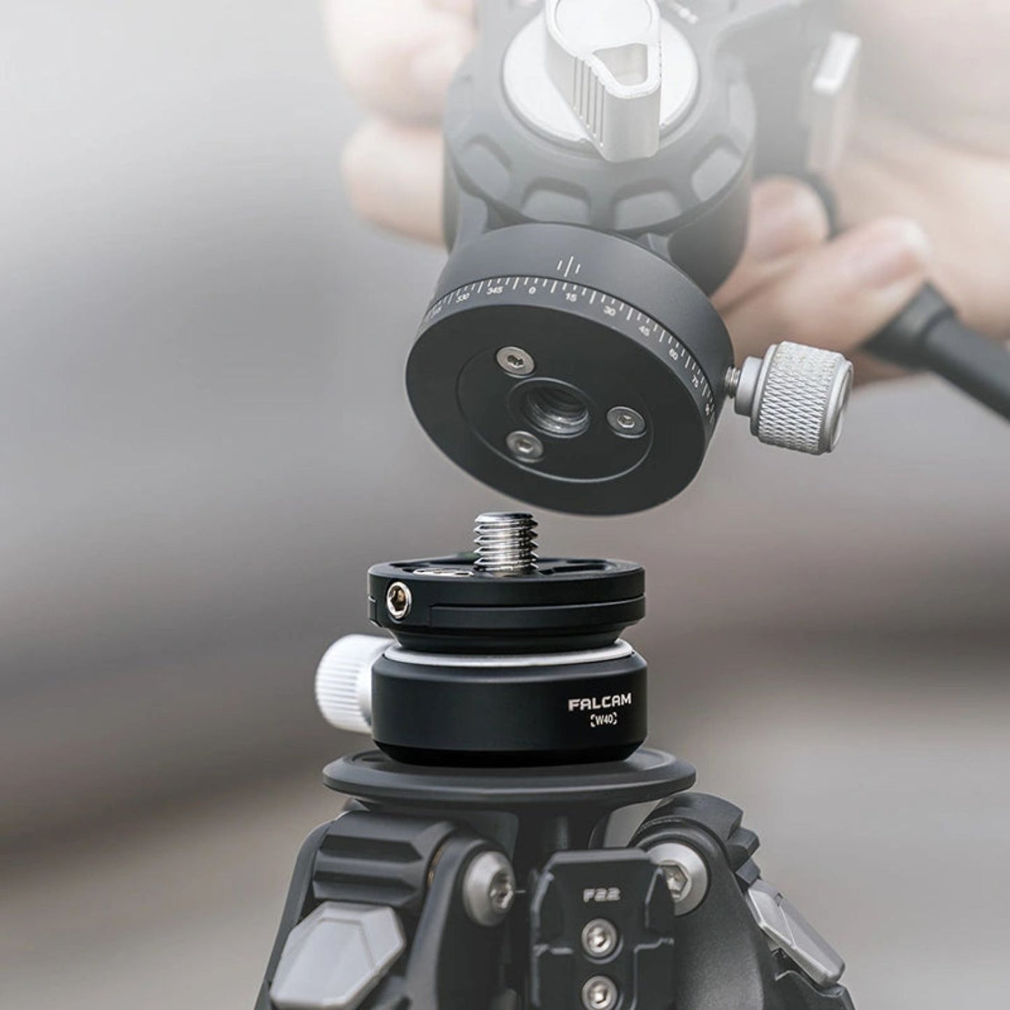 Black ball head with tilt angle ring and side control knob on tripod-style mount
