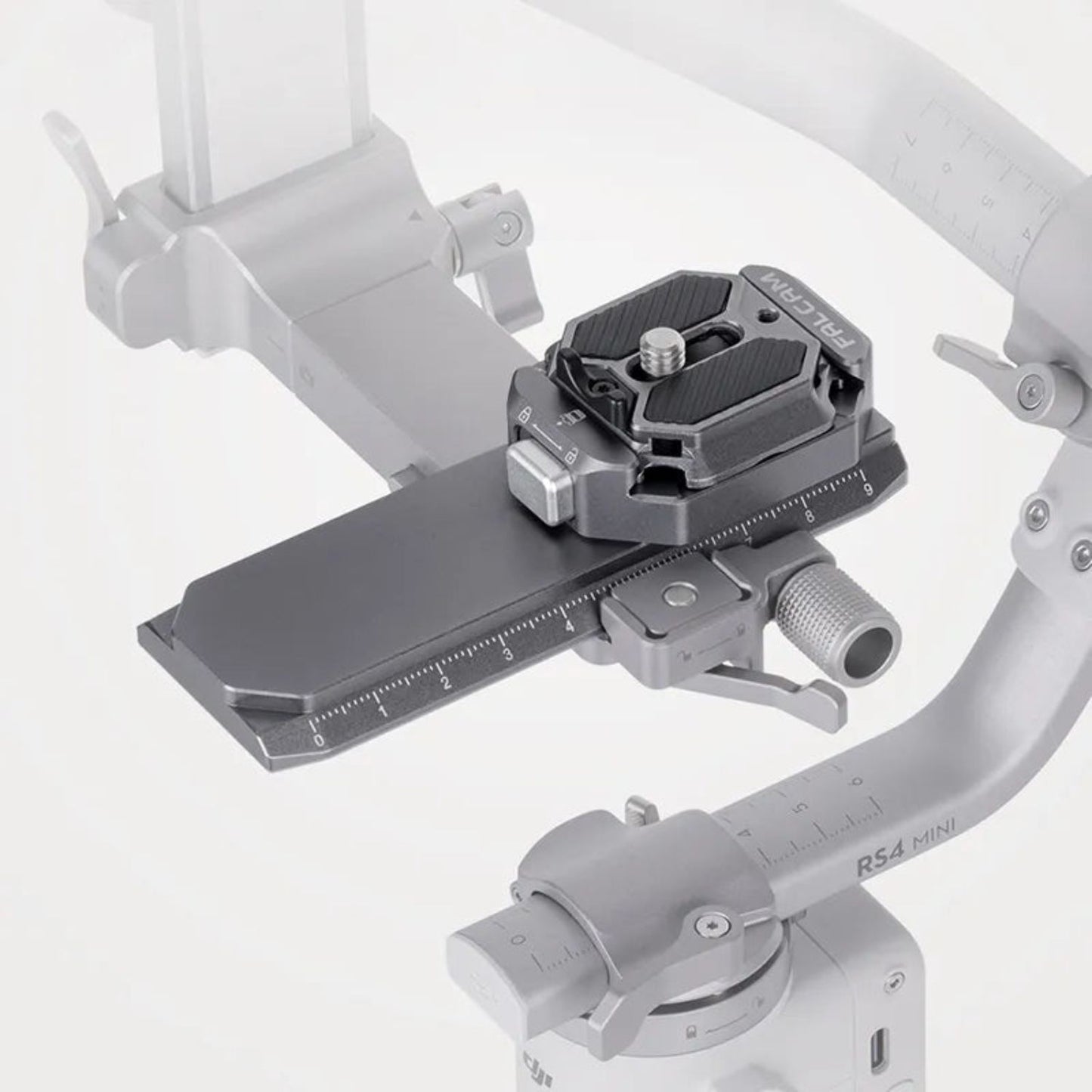 Quick-release rail clamp mounted on a gimbal handle, dark gray