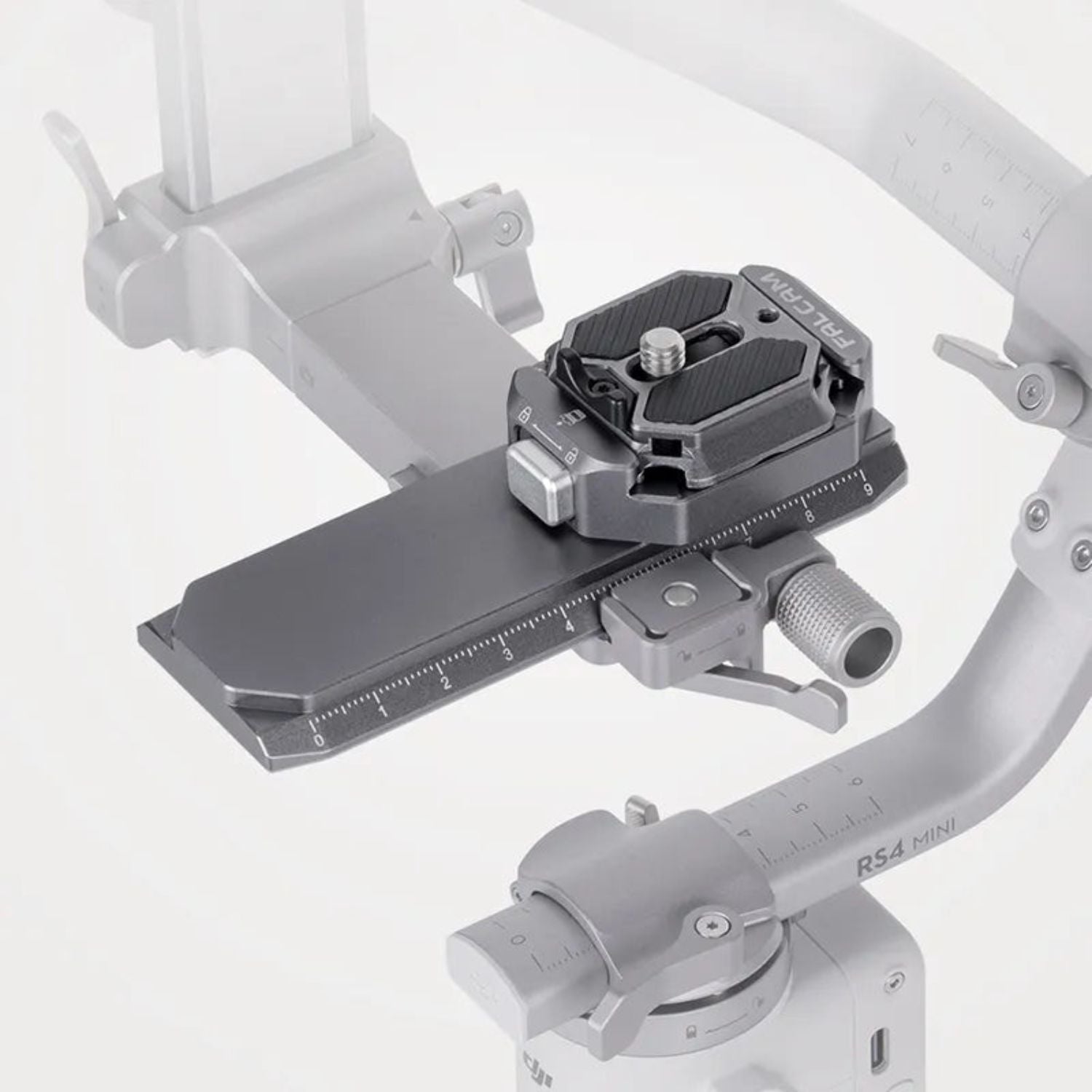 Quick-release rail clamp mounted on a gimbal handle, dark gray