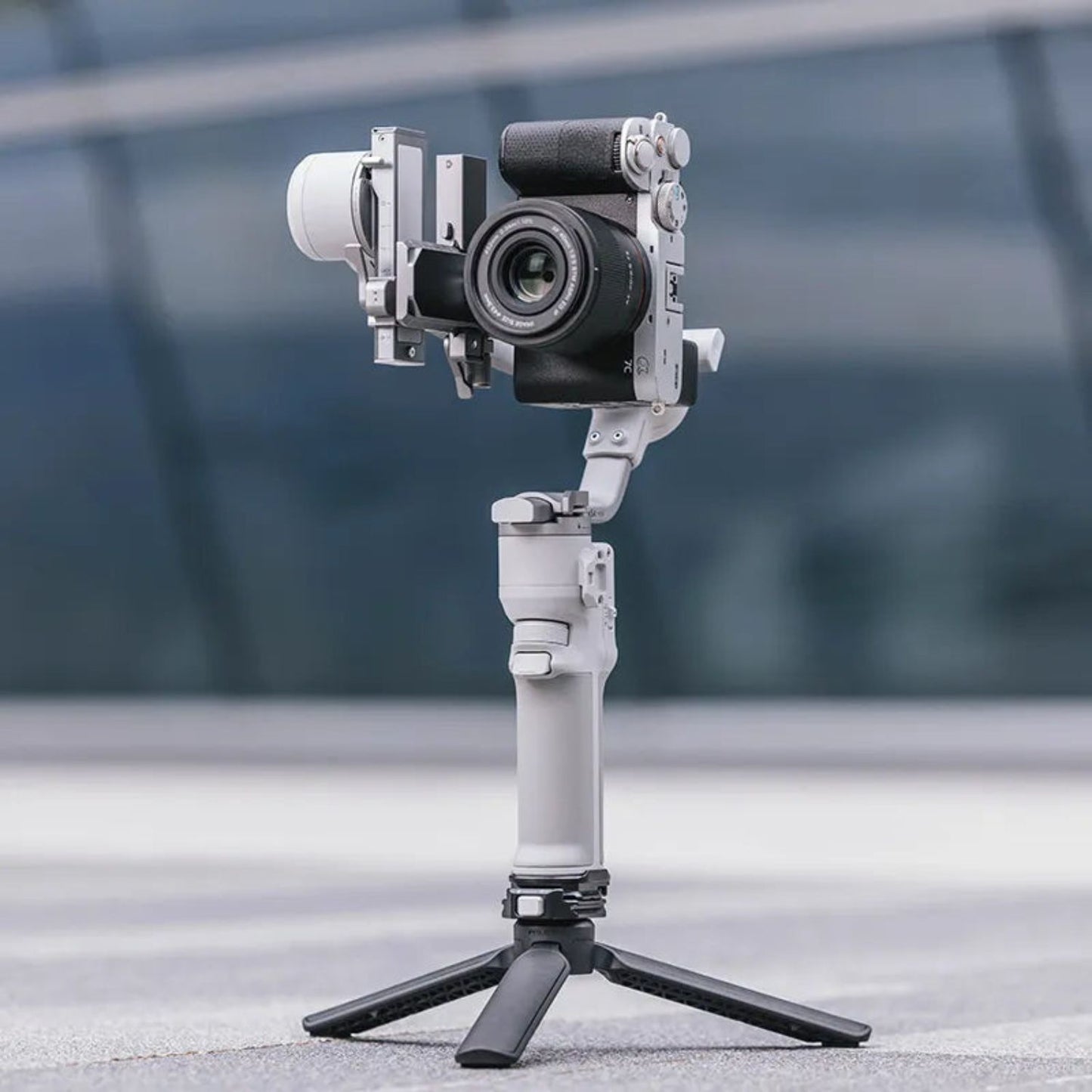 Camera mounted on a gimbal with quick-release clamp and rail, dark gray
