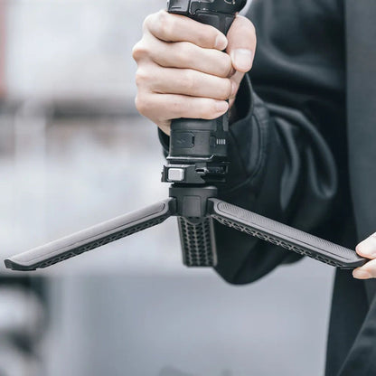 Desktop tripod with three legs opened, supporting a camera platform
