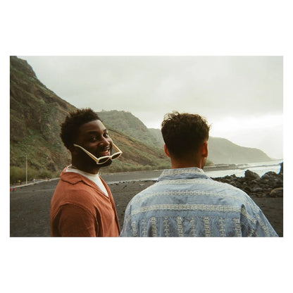 Printed photo showing two people outdoors wearing face masks near a road