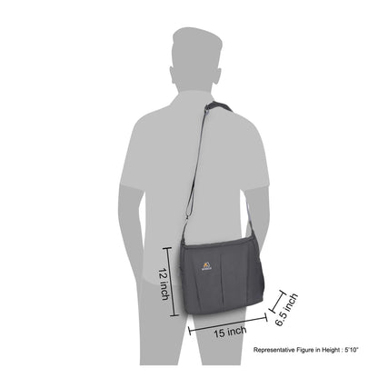 Dark gray sling bag worn crossbody with adjustable shoulder strap