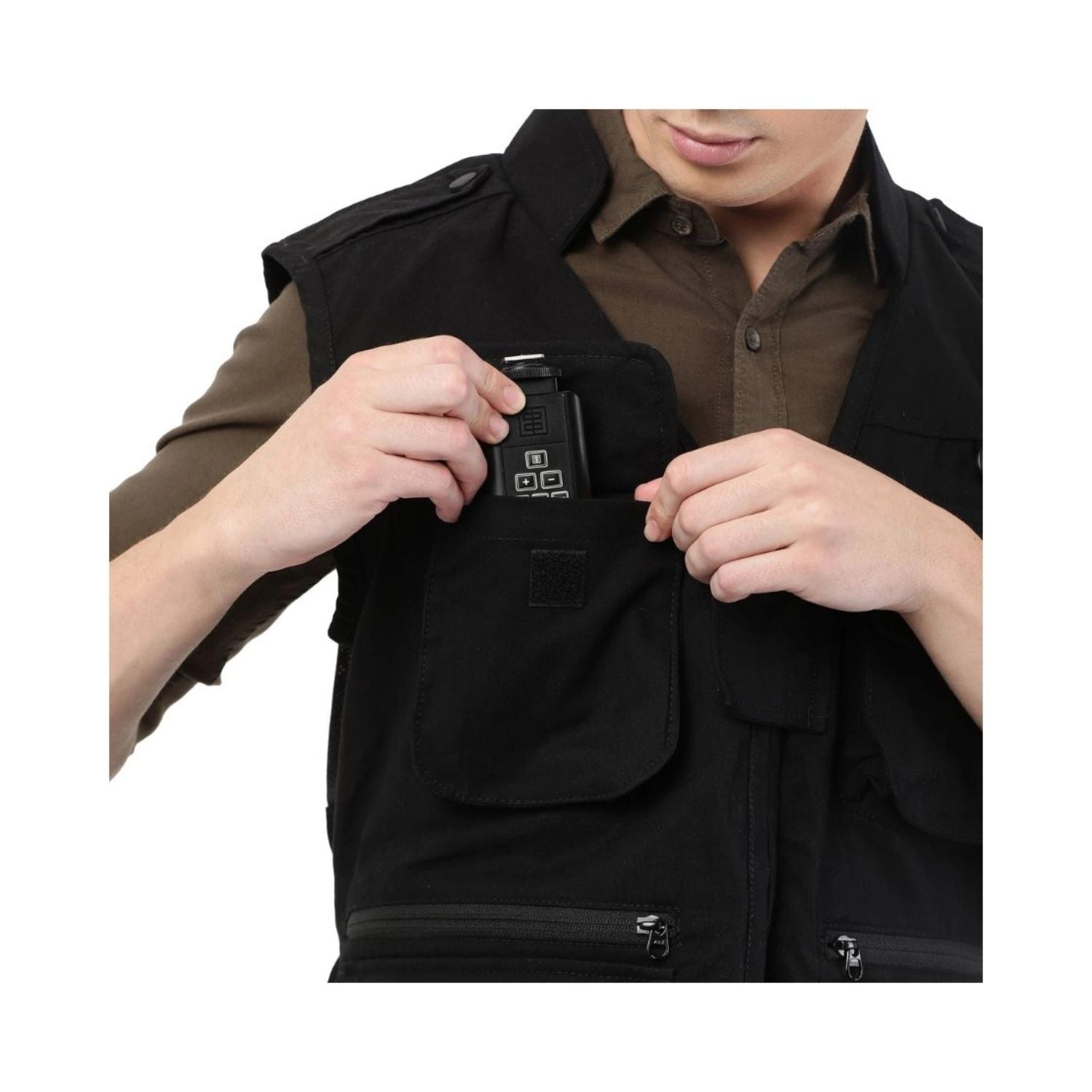 Close-up: black photographer’s jacket with hidden front tech pocket and adjustable strap