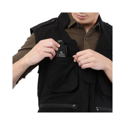 Close-up: black photographer’s jacket with hidden front tech pocket and adjustable strap