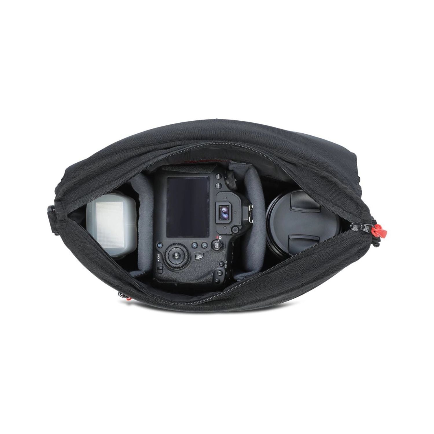 Open black sling bag interior with camera body, lens, and accessory pockets