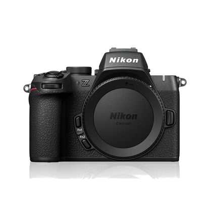 Black mirrorless camera front view with Nikon logo and lens mount cover