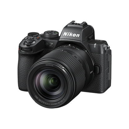Black mirrorless camera with attached lens, three-quarter front view