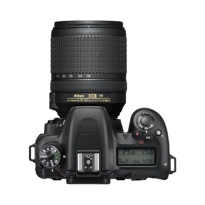 DSLR camera top view with 18-140mm lens, illuminated LCD control screen