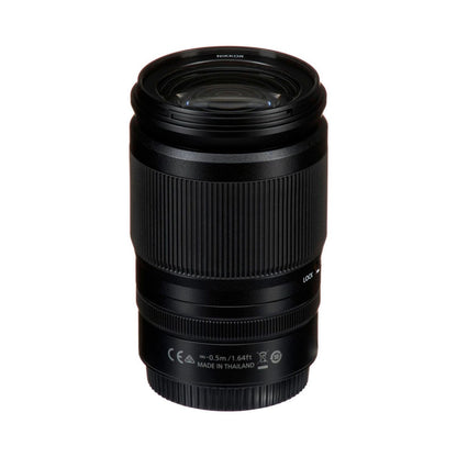 NIKKOR Z 24-200mm lens side view with front glass and compliance markings, black