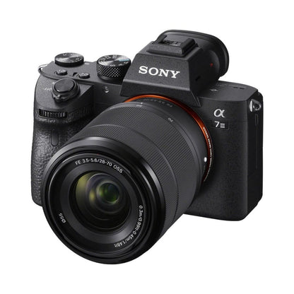 Alpha A7III mirrorless camera with 28-70mm lens, side view, textured grip and controls