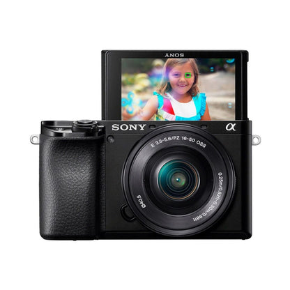 Mirrorless camera with 16–50mm lens, rear LCD screen showing a photo preview