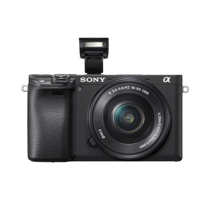 Mirrorless camera with 16-50mm OSS lens, built-in flash raised