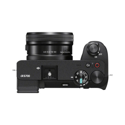 Top view of mirrorless camera with lens and mode dial, power on/off switch