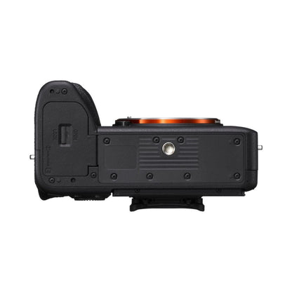 Black mirrorless camera side view with port openings and battery cover