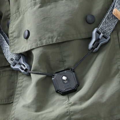 Non-slip quick release plate attached to green fabric with strap lanyard